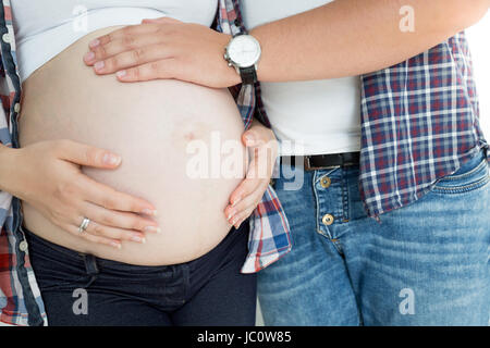 Nahaufnahme Foto des jungen Mannes, die schwangere Frau Bauch zu berühren Stockfoto