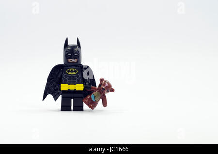 LEGO Batman Minifigur holding Teddybär isoliert auf weißem Hintergrund. Stockfoto