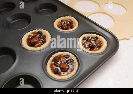 Herstellung von Mince Pies; vier Gebäck gefüllt mit Hackfleisch, Teig Fetzen über Stockfoto