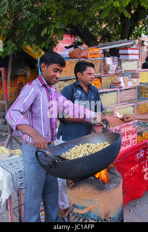 Lokale Mann Rösten Erdnüsse im Johari Bazaar in Jaipur, Indien. Jaipur ist die Hauptstadt und größte Stadt von Rajasthan. Stockfoto