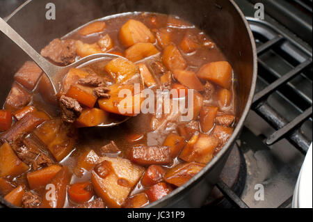 Köstliches Rindfleisch-Eintopf kochen in einem Topf in einer reichen Soße mit Kartoffeln und Karotten für eine traditionelle Lancashire Hotpot Stockfoto