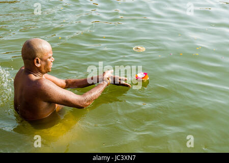 Ein Pilger ist das Beten, mit einem Deepak am heiligen Fluss Ganges Dashashwamedh Ghat, Main Ghat, in der Vorstadt Godowlia Stockfoto