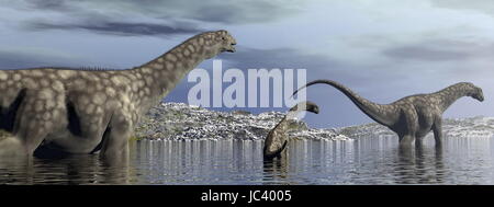 Argentinosaurus Dinosaurier Familie gehen im Wasser durch Morgenlicht - 3D render Stockfoto