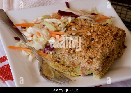 Zucchini-Scheibe mit Krautsalat auf einem weißen Teller serviert. Stockfoto