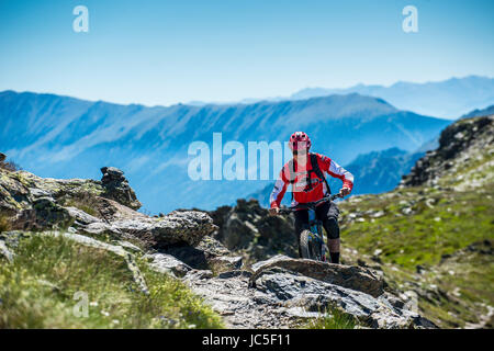 Ein Mountainbiker fährt mit einem Gebirgskamm in Andorra in den Pyrenäen. Stockfoto