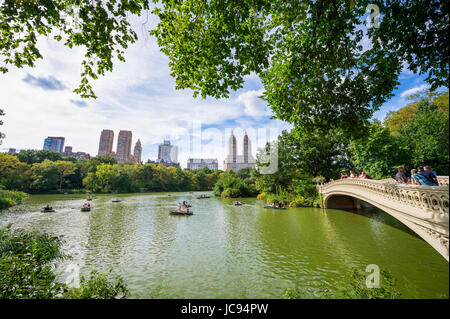 NEW YORK CITY - 3. September 2016: Touristen Ruderboote, den Blick auf die berühmte Skyline von Bogenbrücke und Central Park West auf einen Spätsommer Afte teilzunehmen Stockfoto