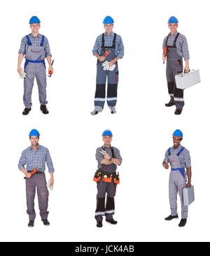 Gruppe von glückliche Arbeiter halten Ausrüstung Over White Background Stockfoto