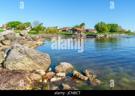 Am Meer-Dorf des Ossby am südlichen Öland in Schweden. Hier aus dem Meer mit Blick auf die verlassenen Bootshaus am Ufer gesehen. Stockfoto