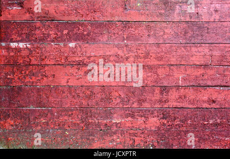 Closeup Textur von einer verschlissenen roten Holzplatte auf einer Scheune Stockfoto