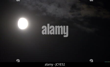 Vollmond hinter Wolken in der Nacht. Stockfoto