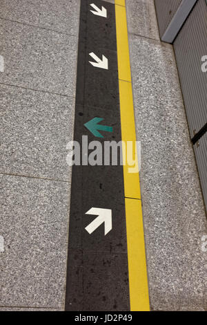 Pfeile auf dem Schneidwerksboden Kwai Hing MTR-U-Bahnhof, Hong Kong Stockfoto