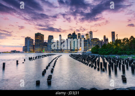 New York City, hölzerne Pfähle und Manhattan bei Sonnenuntergang Stockfoto