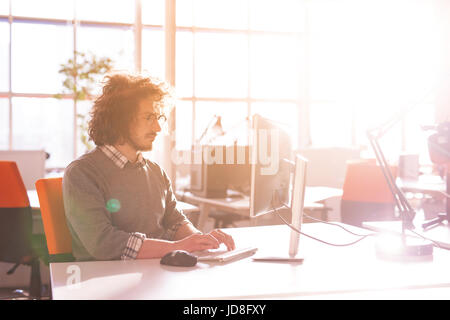 Jungunternehmer-Programmierer in großes helles Büro bei der Arbeit mit computer Stockfoto