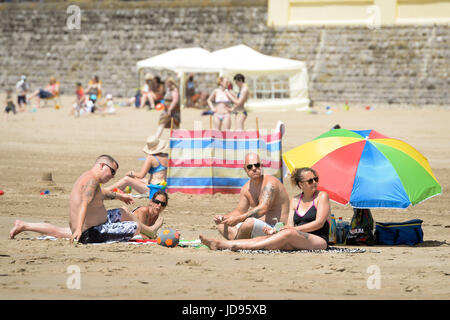 Sonnenanbeter am Strand von Barry Island, South Wales, wo Temperaturen in den hohen zwanziger Jahren sind und Menschen strömen in das Meer, das herrliche sonnige Wetter zu genießen. Stockfoto