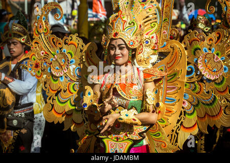 Schöne balinesische Frau gekleidet in voller Karneval Insignien für die street Parade anlässlich der Eröffnung des Bali Arts Festival 2017. Atemberaubende Kostüm Stockfoto