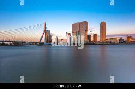 Am Flussufer Blick vom Ufer der Maas, die Anzeigen von den financial District "Kop van Zuid" und der Erasmusbrücke, bilden eine schöne Skyline bei Sonnenuntergang. Stockfoto