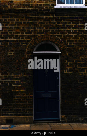 stilvolle Eingang eines Wohnhauses, wölbt sich eine interessante Fassade des alten Steins über der Tür, eine typisch englische Altbauten, london Stockfoto