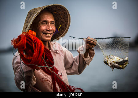 Glücklich vietnamesische Fischer mit seinem Fang Stockfoto