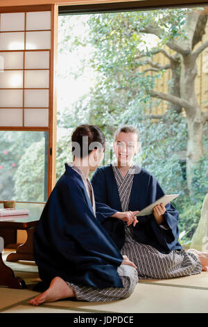 Kaukasische Trägerin Yukata mit japanischer Freund im traditionellen Ryokan, Tokyo, Japan Stockfoto