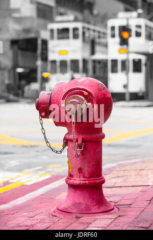 Vintage Red Fire Hydrant in Hong Kong Bürgersteig und zwei Straßenbahnen am Verkehr Hintergrund (Farbe-Taste) Stockfoto