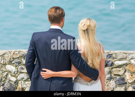 Braut und Bräutigam an einem Strand mit Fotos für ihre Hochzeit. Ehepaar. Zu heiraten. Tag der Ehe. Stockfoto