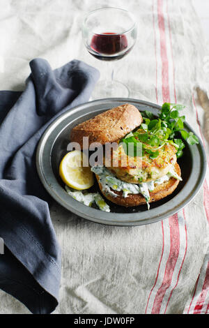 Forellen-Tzatziki-Burger auf Platte Stockfoto