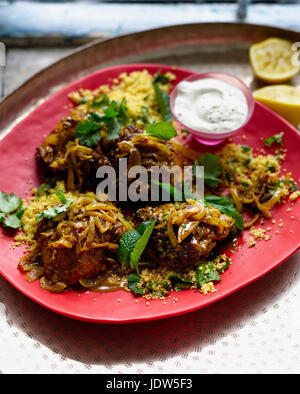 Teller mit Harissa Hühnchen mit Couscous und Minze Joghurt Stockfoto