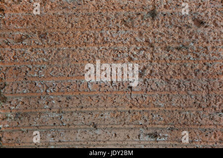 Abstrakte rötlich düstere konkrete Hintergrundtextur. Stockfoto