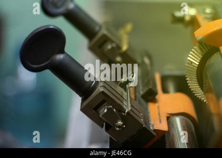 Maschinelle Fertigung von doppelte Metall Schlüssel. Der Schlüssel des gelben Metalls. Stockfoto