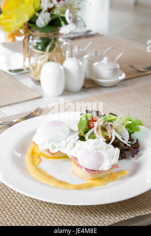 Eggs Benedict - geröstete englische Muffins, Schinken und Spiegeleiern buttrig Hollandaise Soße zum Frühstück Stockfoto