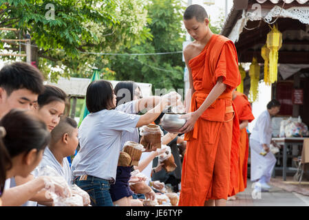 PHAYAO, THAILAND-Oktober 24, 2016: Mutter Tochter und thai-Buddhisten machen Verdienst mit Angebot klebrigen Reis und Essen zu Mönch Schüssel am Morgen Stockfoto