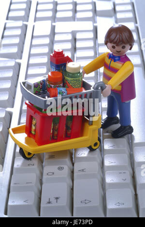 Charakter von Einkaufswagen auf Computer-Tastatur, Stockfoto
