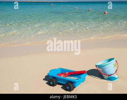Kinder Schaufel und Spaten Kunststoff Spielzeug am Strand im Sommer auf tropischen Ozean Küste Stockfoto