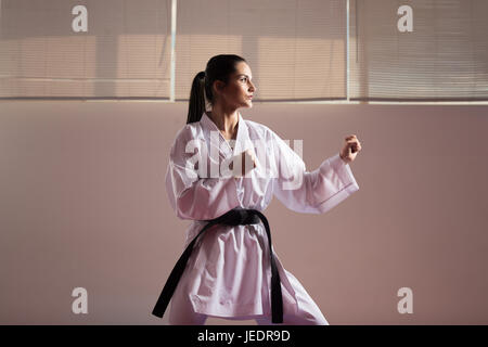 Junge Frau, gekleidet In traditionellen Kimono üben ihre Karate-Moves - Schwarzgurt Stockfoto