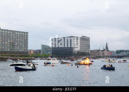 Kopenhagen, Dänemark - 23. Juni 2017: ein Feuer im Hafen für die traditionelle Mittsommerfest. Zuschauer in Boote beobachten die Veranstaltung. Stockfoto