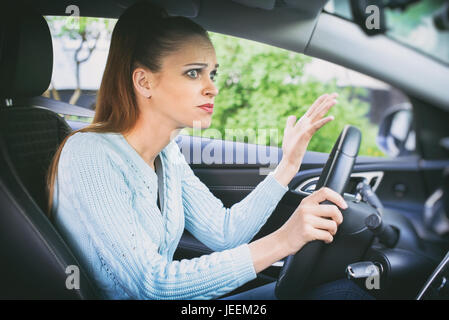 Angst, hübsches Mädchen, ein Auto zu fahren. Schockiert Frau in einem Auto Stockfoto