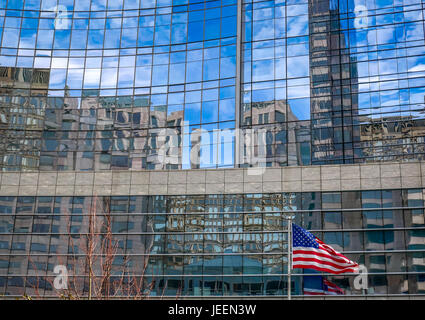 Amerikanische Flagge und Fahnenmast vor hohes modernes Gebäude aus Glas mit Wolkenkratzer Reflexionen, die Innenstadt von Boston, Massachusetts, USA Stockfoto