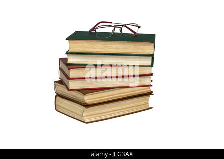 Auf einer weißen Fläche ist ein Haufen Bücher und Lesebrille Stockfoto