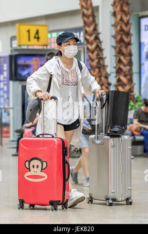 PEKING-21. MAI 2016. Mädchen mit Mundkappe am Bahnhof Peking Süd, der größten Station der Stadt, einer der größten in Asien. Stockfoto