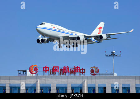 PEKING, 5. JULI. Air China Cargo Boeing 747-412BCF, B-2453 überfliegt das Gebäude der China Aviation Oil Corporation. Stockfoto