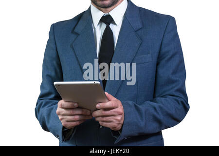 Geschäftsmann in einer Jacke hält eine Tablette Stockfoto