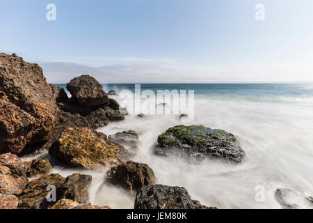 Pazifikküste Felsen und Wellen mit Motion blur bei Point Dume in Malibu, Kalifornien. Stockfoto