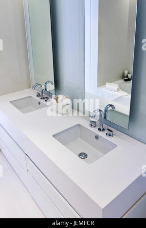 Modernes, elegantes weißes Design Badezimmer mit großer vertikaler Spiegel, geschossen von einem hohen Winkel. Stockfoto
