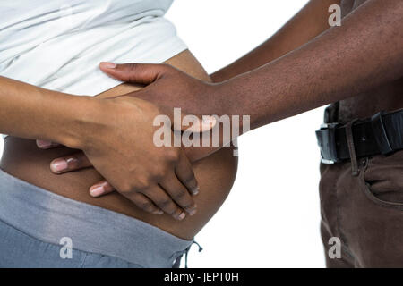 Man berühren schwangere womans Magen Stockfoto