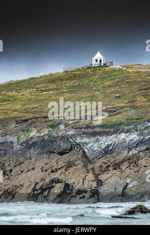 Dunkle Regenwolken über eine kleine weiße Suche Gebäude an der Oberseite Towan Landzunge in Newquay, Cornwall. Stockfoto