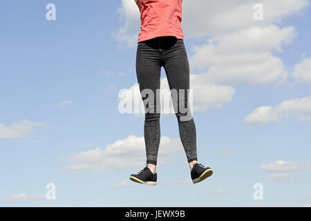 Fröhliche junge Frau springen Stockfoto