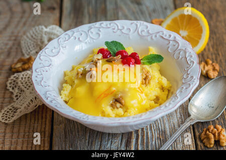 Schüssel mit millet Porridge, Zitronencreme und Muttern. Stockfoto