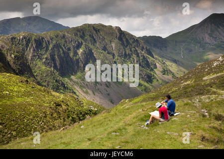 UK, Cumbria, Fleetwith Pike, Wanderer saß am Boden Blick auf Karte mit Blick auf Heu stapeln Stockfoto