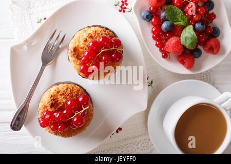 Leckeres Frühstück, Kokos Muffins, Beeren und Kaffee mit Milch Nahaufnahme auf dem Tisch. horizontale Ansicht von oben Stockfoto