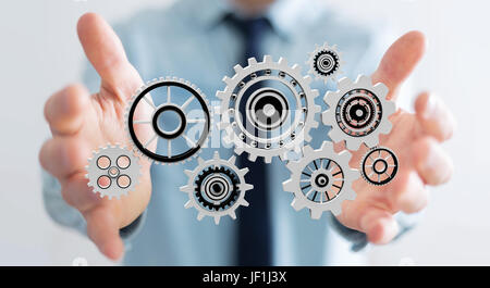 Geschäftsmann auf schwimmende Getriebe Icons in seiner Hand 3D-Rendering hält der Hintergrund jedoch unscharf Stockfoto